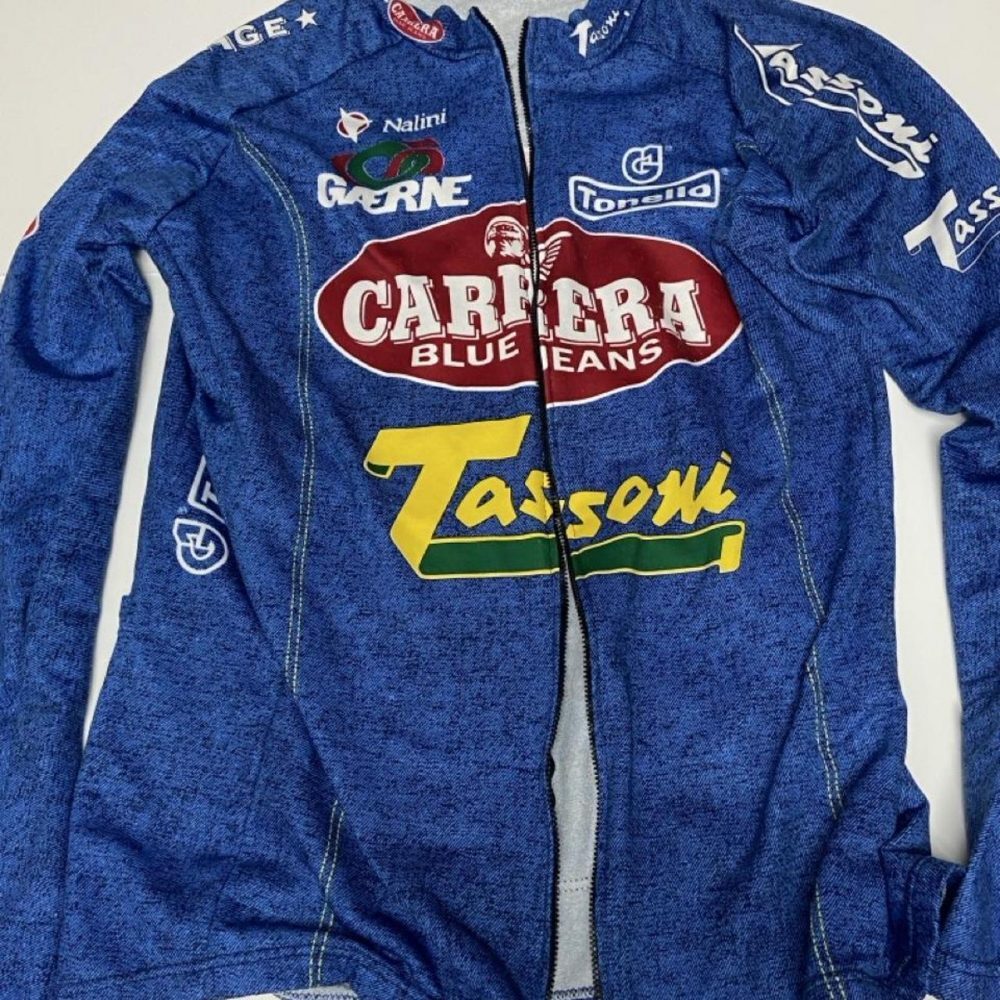 Blue denim jacket with yellow/green 'Tassoni' logo and red oval 'Carrera Blue Je